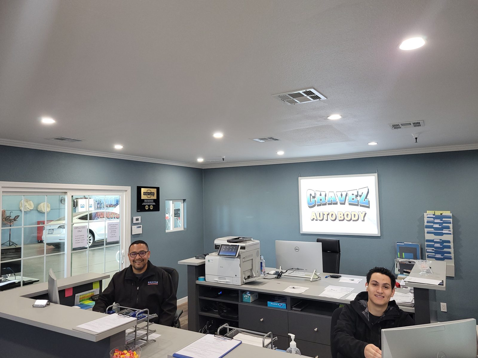 The owners at the Chavez Auto Body front desk